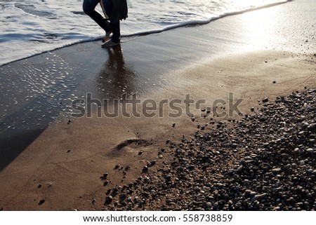 Young man walking on the beach 