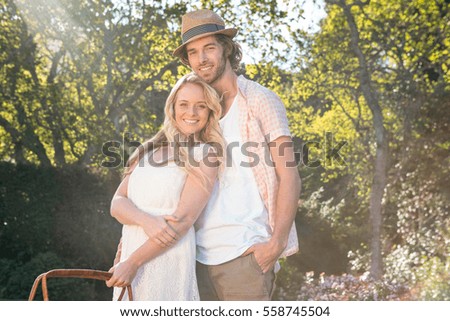 Happy couple having a picnic and embracing in the garden