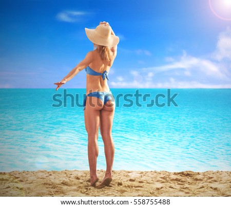 Feeling the sun at beautiful beach. sunbathing fitness woman looking the sea waiting the boat.