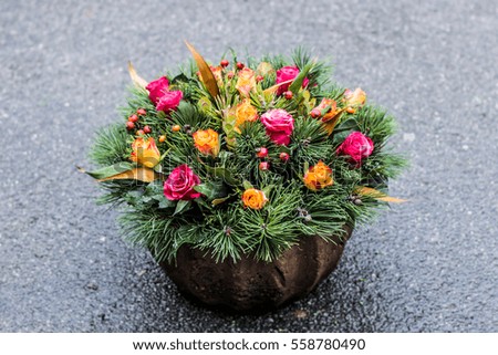 Colorful flower arrangement wreath ikebana for funerals on a blured background