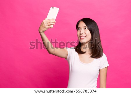 Woman taking selfie by mobile phone