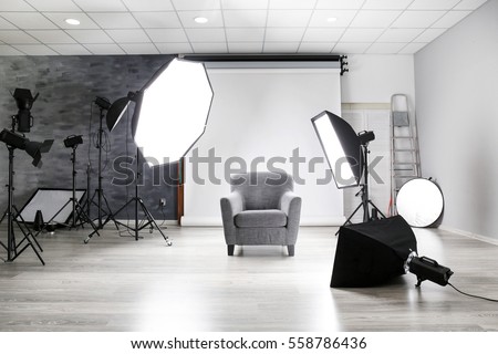 Photo studio with modern interior and lighting equipment Royalty-Free Stock Photo #558786436
