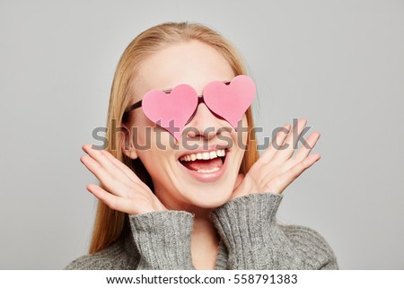 Woman in love with two pink hearts over her eyes Royalty-Free Stock Photo #558791383