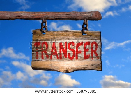 Transfer motivational phrase sign on old wood with blurred background