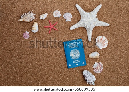 passport of Kazakhstan and sea shells lying on cork board