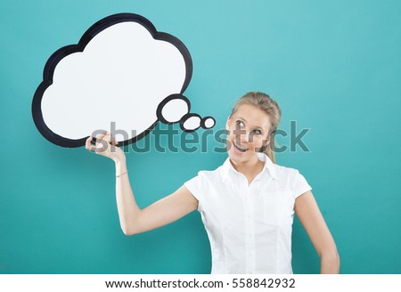 pretty young blond caucasian woman smiling with comic baloon  on blue background