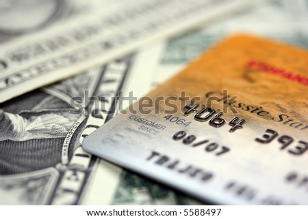 Close up picture of credit card putted on dollars