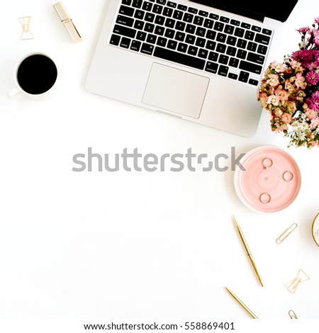 Top view home office desk. Workspace with laptop, wildflowers bouquet, coffee cup, golden pen, clips and accessories. Flat lay