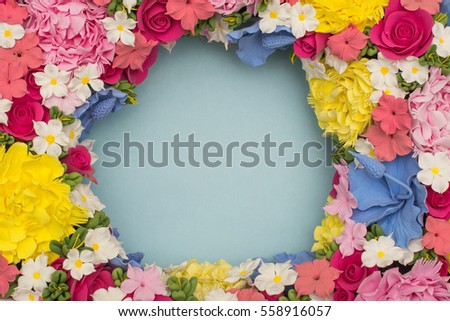Blue background with red, pink, white, purple flowers in a circle. Postcard for the holiday (Mother's Day, Easter, birthday, congratulations, Valentine's Day). Place for writing (letters). mock up 