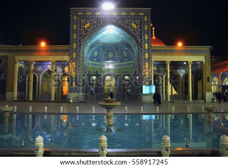 Beautiful night view of Fatima Masumeh (Mosoumeh, Al-Masumah) Shrine portal decorated with blue tile and water pool in Qom (Qum, Komb, Koama) - the holy city for Shia Muslims, Iran, Middle East Royalty-Free Stock Photo #558917245