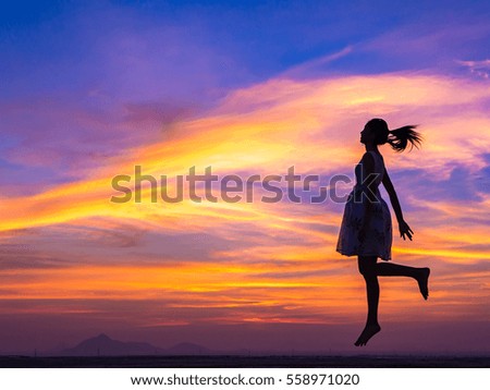 Successful woman jumping, dancing and having fun on sunset. Freedom and happiness concept. Girl celebrating work out success.