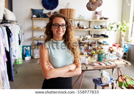 Young female business owner in a clothes shop, portrait Royalty-Free Stock Photo #558977833