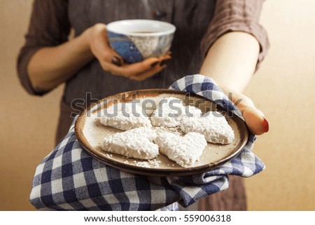 Hands holding valentine biscuit and coffee. Valentine's Day Concept