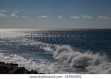 Wave coming from still ocean daytime