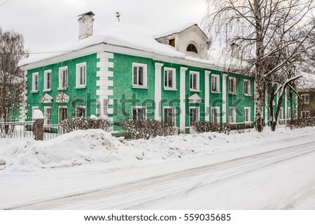 Green residential house in a residential area. Walking area. Winter landscape. Open space. Contemporary Russia. 