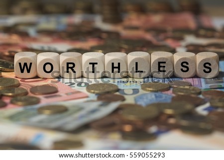 worthless - cube with letters, money sector terms - sign with wooden cubes