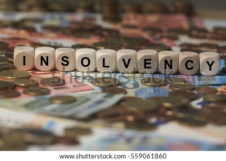 insolvency - cube with letters, money sector terms - sign with wooden cubes Royalty-Free Stock Photo #559061860