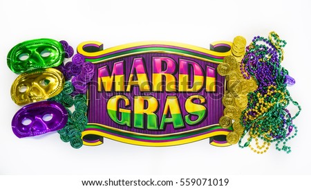 Mardi Gras beads, masks and banner reading  Mardi Gras in traditional festive colors on a white background in horizontal or landscape format with lots of copy space