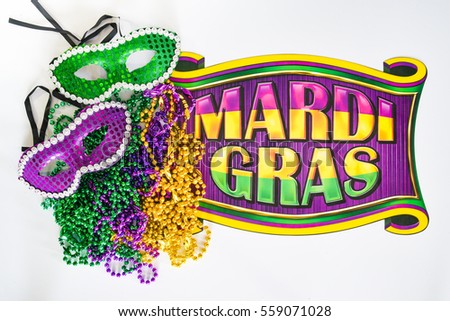 Mardi Gras beads, masks and banner reading  Mardi Gras in traditional festive colors on a white background in horizontal or landscape format 