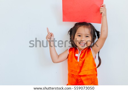 Happy Chinese new year. Portrait of a young asian little girl holding a blank sign red paper on white background