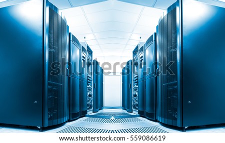 symmetrical data center room with rows of equipment Royalty-Free Stock Photo #559086619