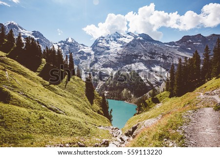 Glacier pond Oeschinensee. Popular tourist attraction. Picturesque and gorgeous scene. Location Swiss alps, Kandersteg, Bernese Oberland, Europe. Vintage effect. Instagram filtered. Beauty world.