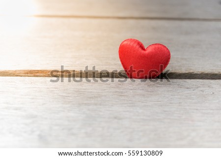red satin hearts on wooden background. Love and Valentine day concept.