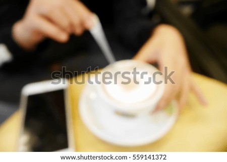 Picture blurred  for background abstract and can be illustration to article of woman with coffee and smartphone