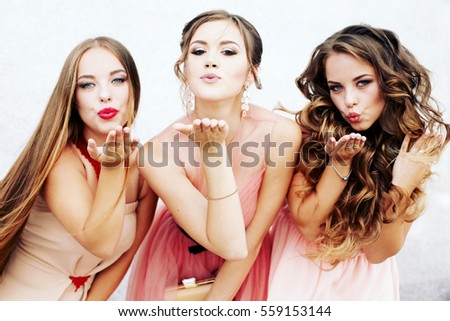 Three happy beautiful brides together. Party time of stylish women group in elegant dress celebrating birthday, having fun, wedding, prom. Friends posing for the camera