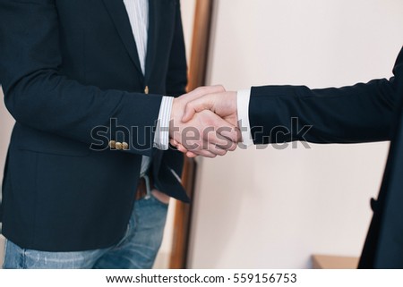 Business partnership meeting. Picture businessmens handshake. Successful businessmen handshaking after good deal.