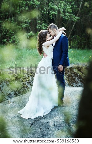 couple bride and groom walking in a summer forest
