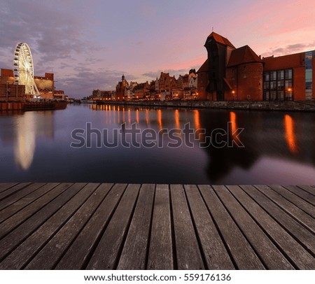 Background with wooden floors and Gdansk cityscape, after sunset. Poland, Europe.