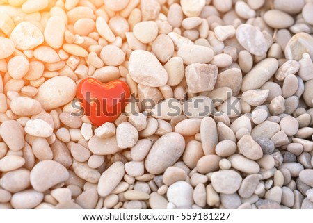 Red heart in pebbles at sunset. Journey. Love