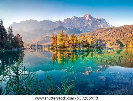 Colorful summer morning on the Eibsee lake with Zugspitze mountain range. Sunny outdoor scene in German Alps, Bavaria, Garmisch-Partenkirchen village location, Germany, Europe. 