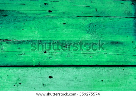 Texture of old wooden fence painted in green color