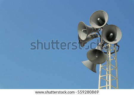 Loudspeaker warning system. System of alert for population. Sound amplifier with loudspeaker against the sky Royalty-Free Stock Photo #559280869