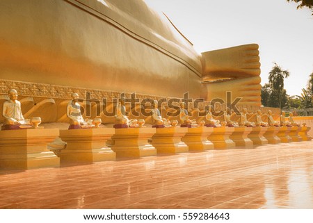 Replica statue of gold Buddha sitting in a row.