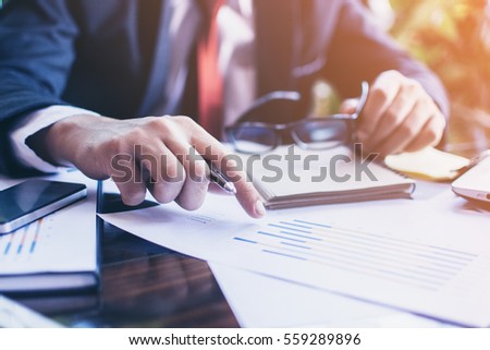 Businessman working with sheet analysis charts.pointing