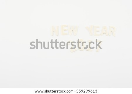 2017 Happy New Year wooden textured wording isolated on white background.