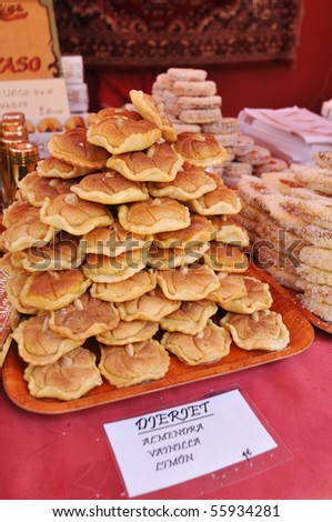 Buying Authentic Mediterranean Arabic style almond lemon flavored cookies at medieval street fair in alicante spain