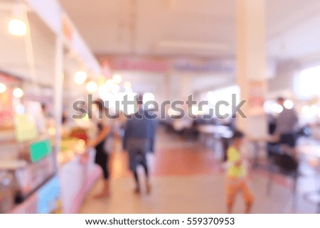 blurred photo of people in market.