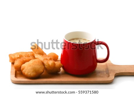 Soybean milk in red cup with Chinese doughstick on white background 