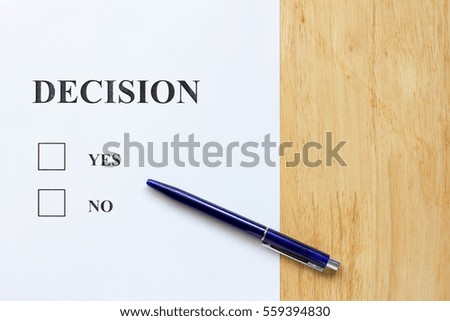 Decision paper with yes and no choice on wood background