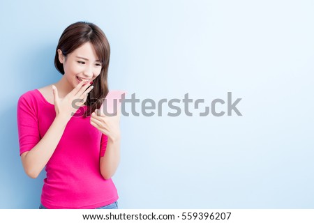 beauty woman use cellphone isolated on blue background