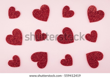 background of glitter red heart pieces pattern on pink paper