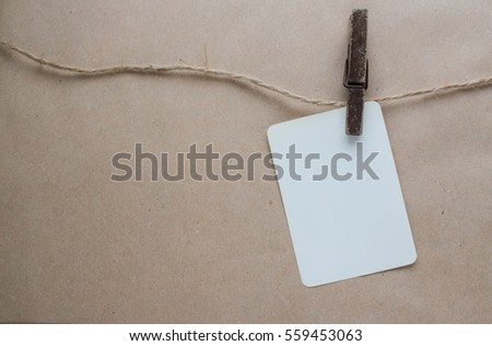 mockup with a sheet of paper on a clothespin on the rope crafting background 