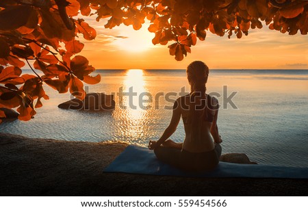 serenity and yoga practicing at sunset,meditation Royalty-Free Stock Photo #559454566