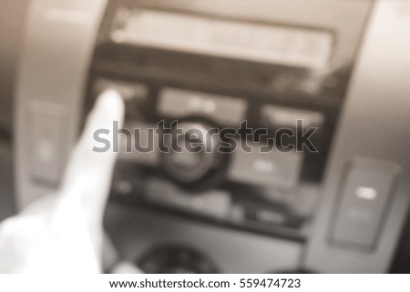 Picture blurred  for background abstract and can be illustration to article of hand adjusting the sound volume in the car stereo