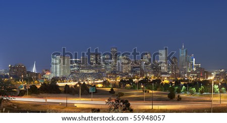 Denver skyline at night. Summer 2010. Focus on skyscrapers. Automobile traffic lights in foreground