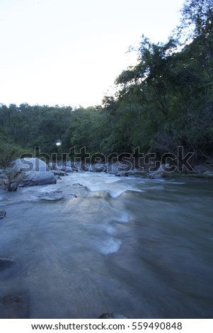 Landscape photography of water moving in the nature forest with rocks background.